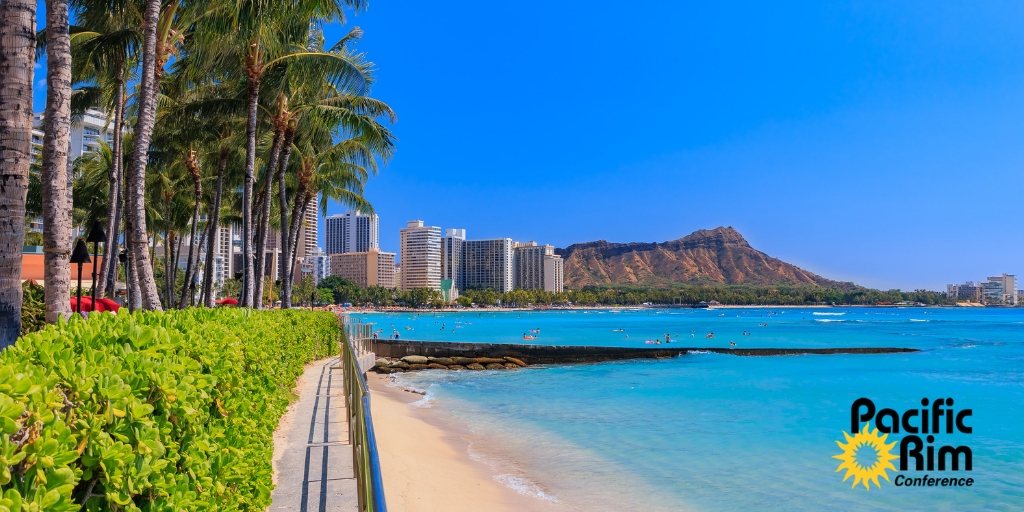 Panorama of Waikīkī Beach and Diamond Head, Honolulu, under a blue sky.